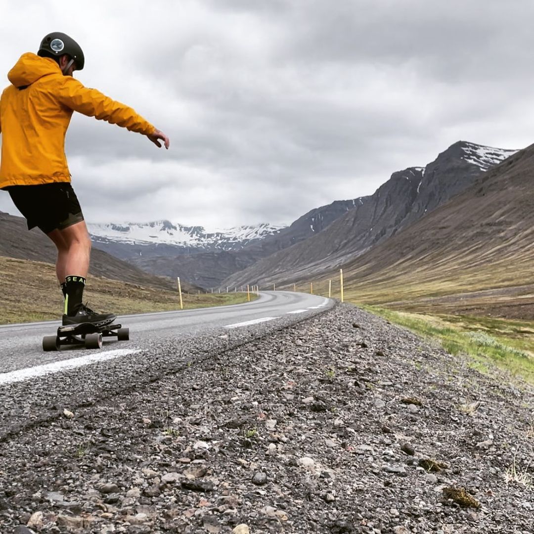 Duncan skateboarding in Iceland with mountains in the background