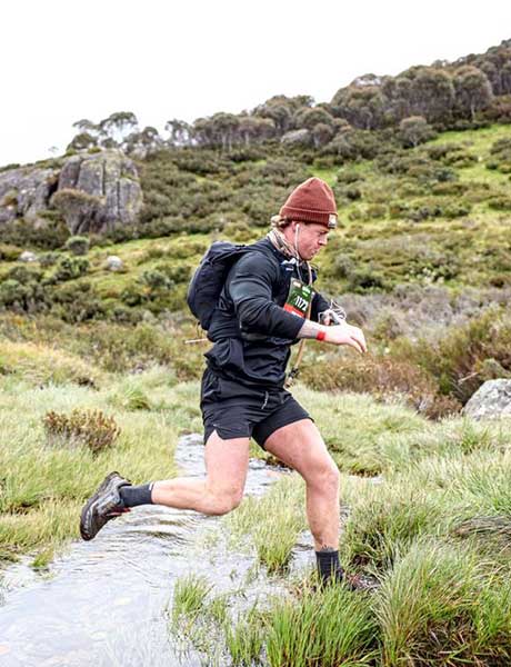 Adam Green on a trail running track wearing Altra trail running shoes