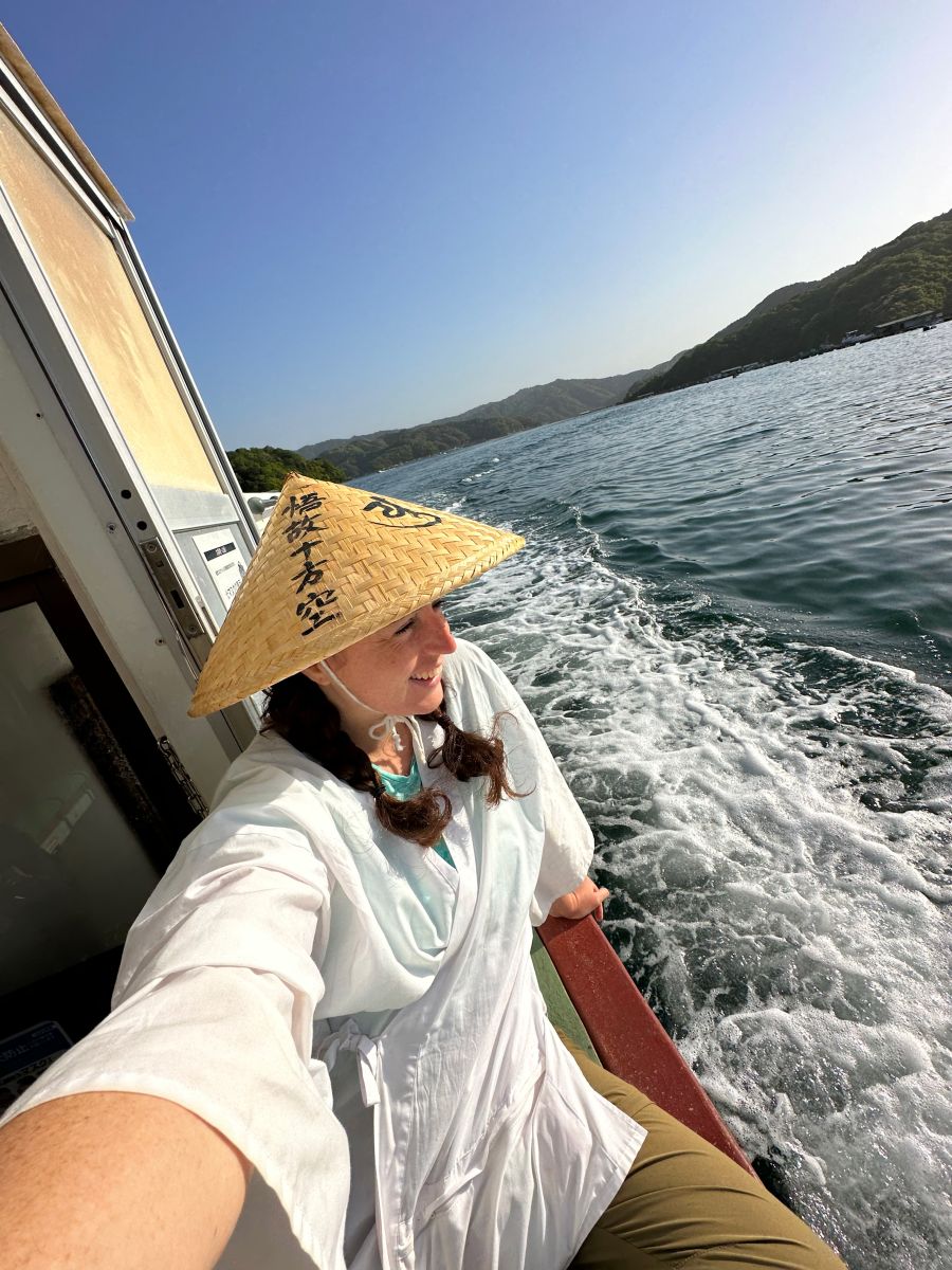 Kiera on the ferry crossing with mountains in the background