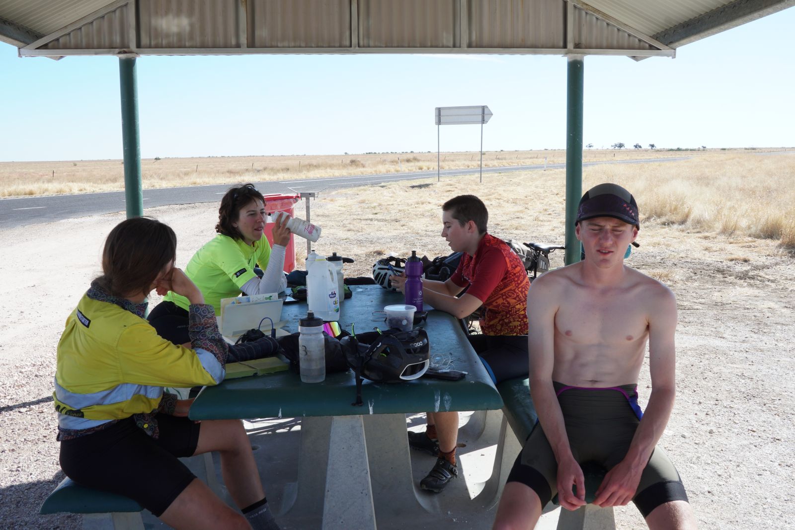 5 people eating around a rest stop table