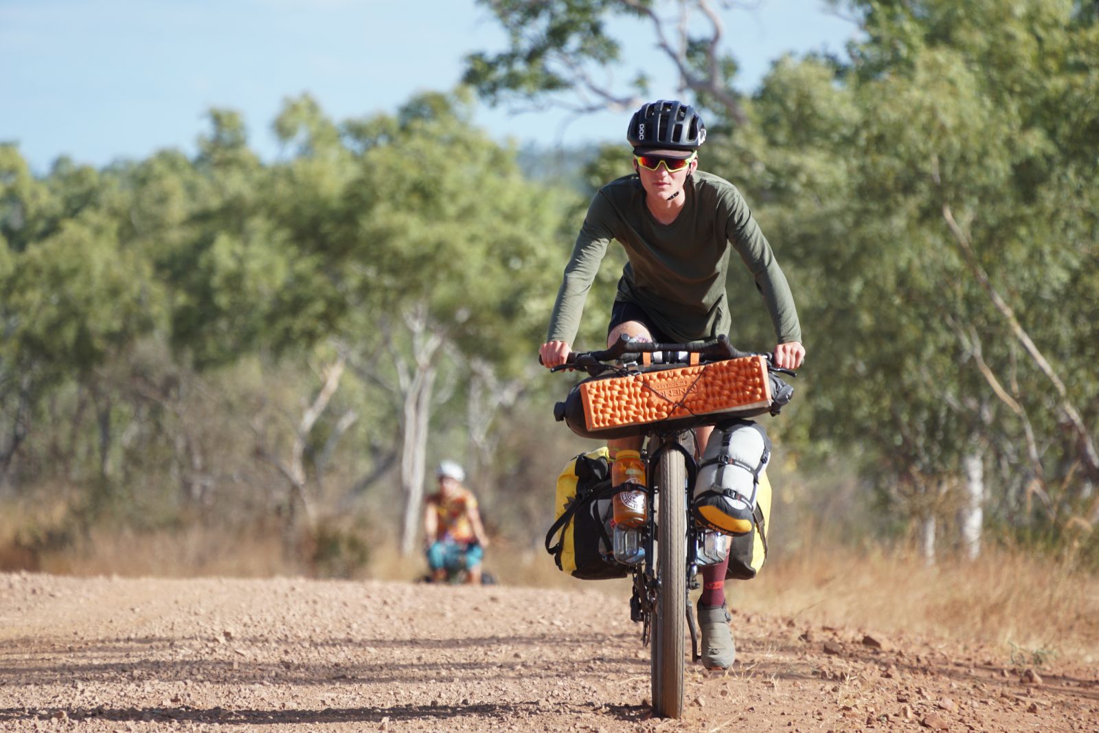 Person riding a bike with a long sleeve top on