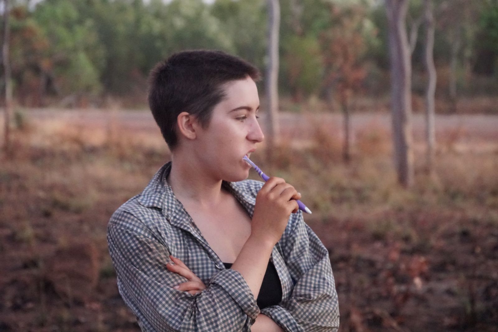 Person brushing their teeth at camp