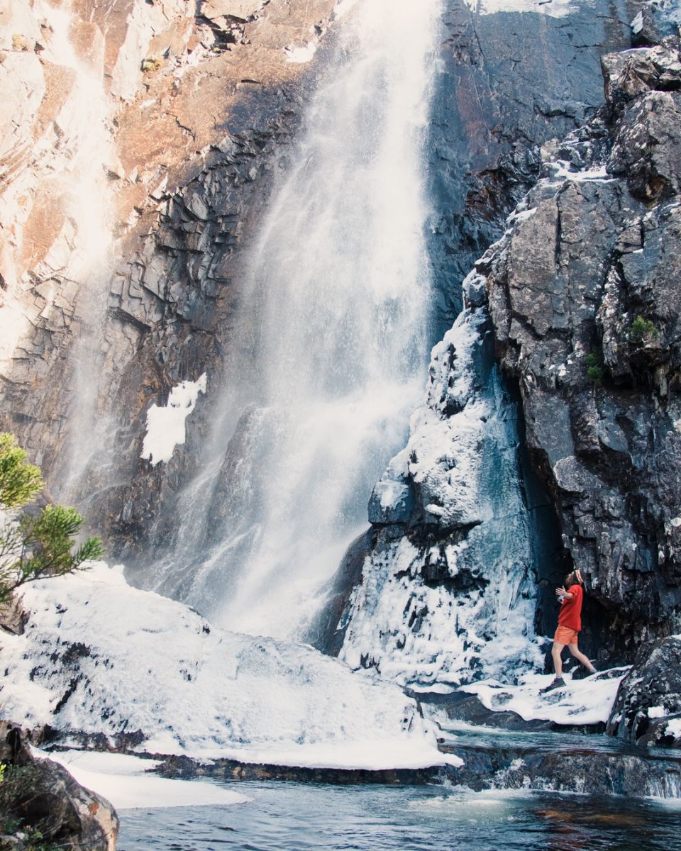 Person standing under waterfalls