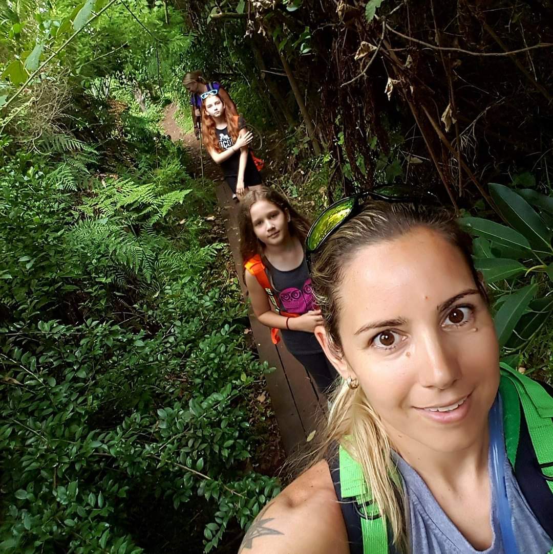 Dani walking through the bush with her two daughters