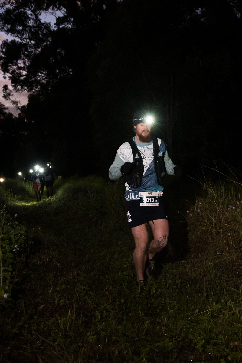 Adam running in the dark wearing a head torch