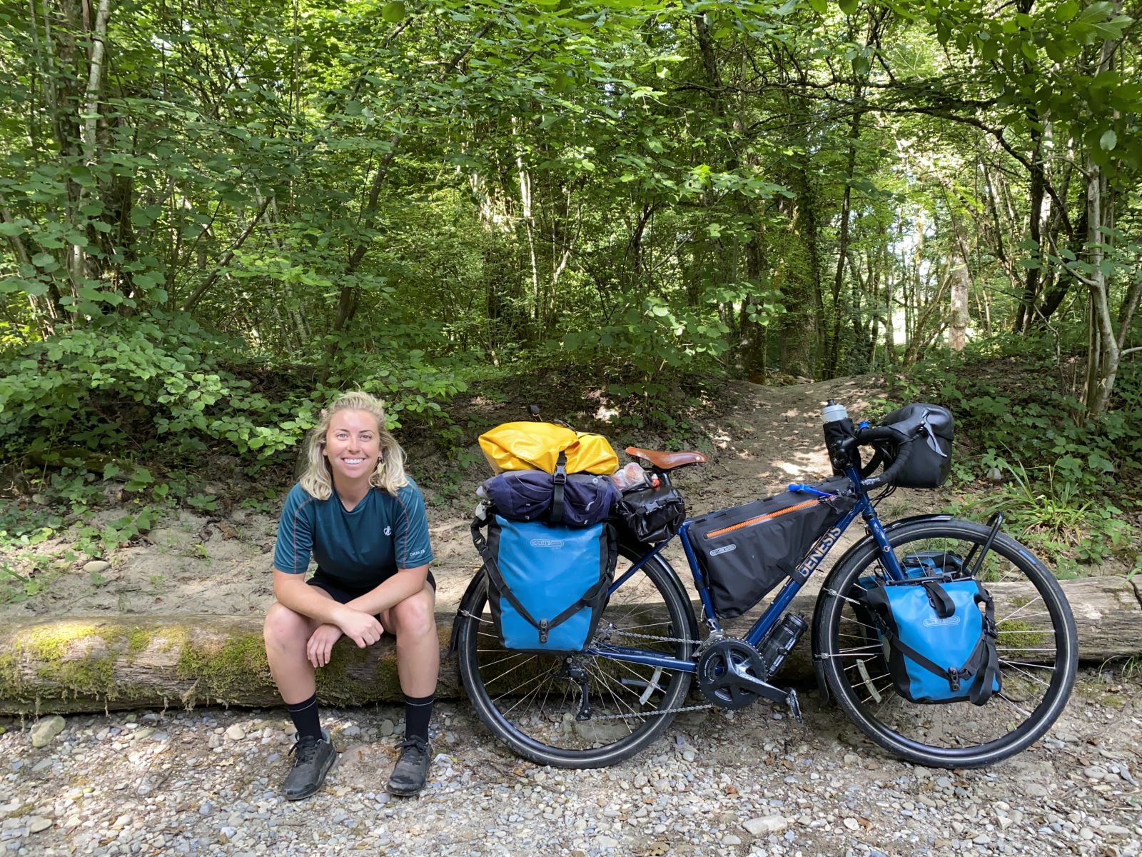 Steph - a woman in her 20s sitting next to her bike