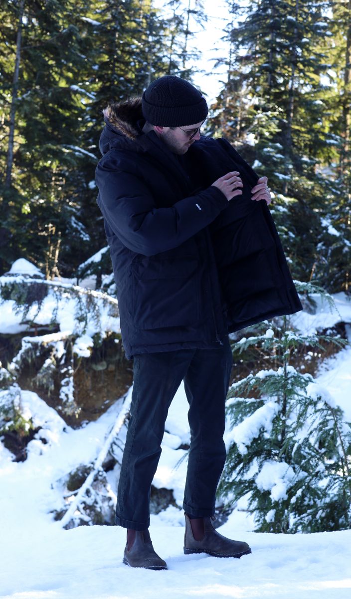 Male wearing The North Face McMurdo jacket unzipped in snow