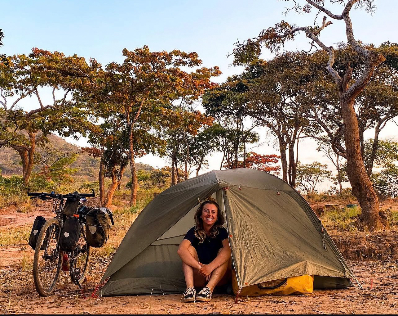 Steph with her bike in Africa