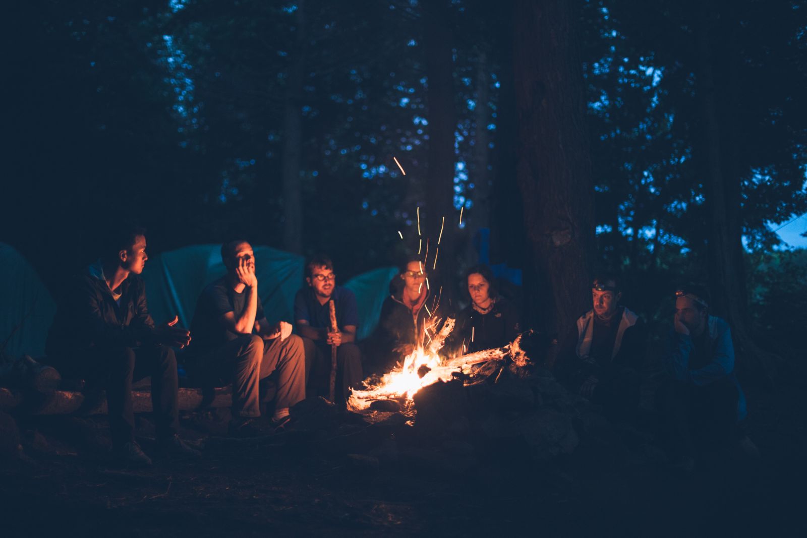 Friends sitting around a campfire