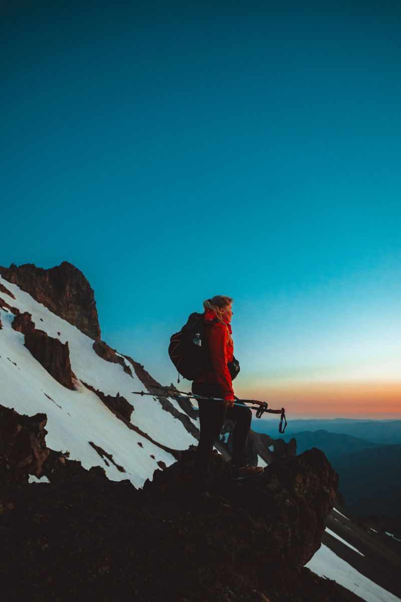 Jactina standing on a snowy peak looking out to the horizon