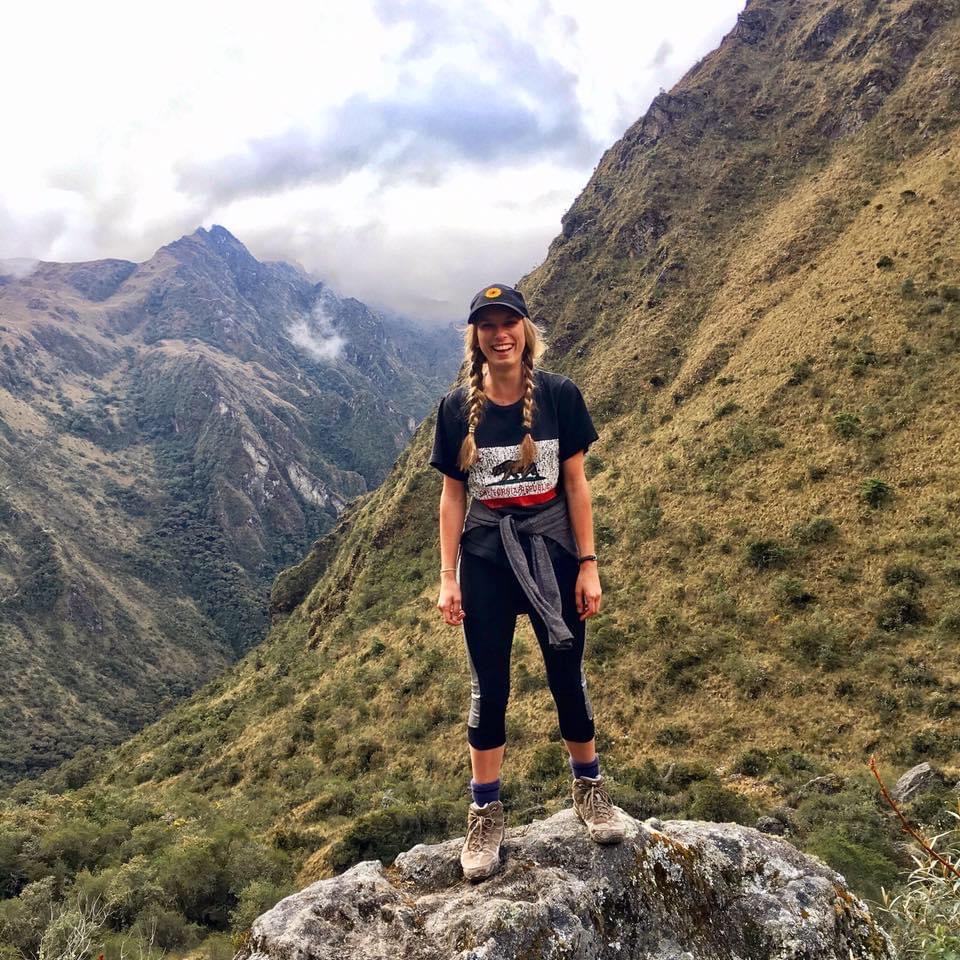 Jess standing on a rock in the mountains