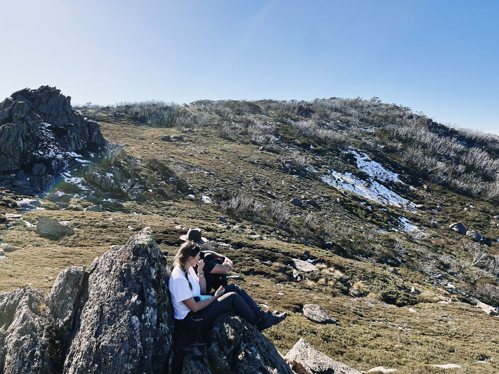 Josh and Kate hiking in an alpine landscape during summer