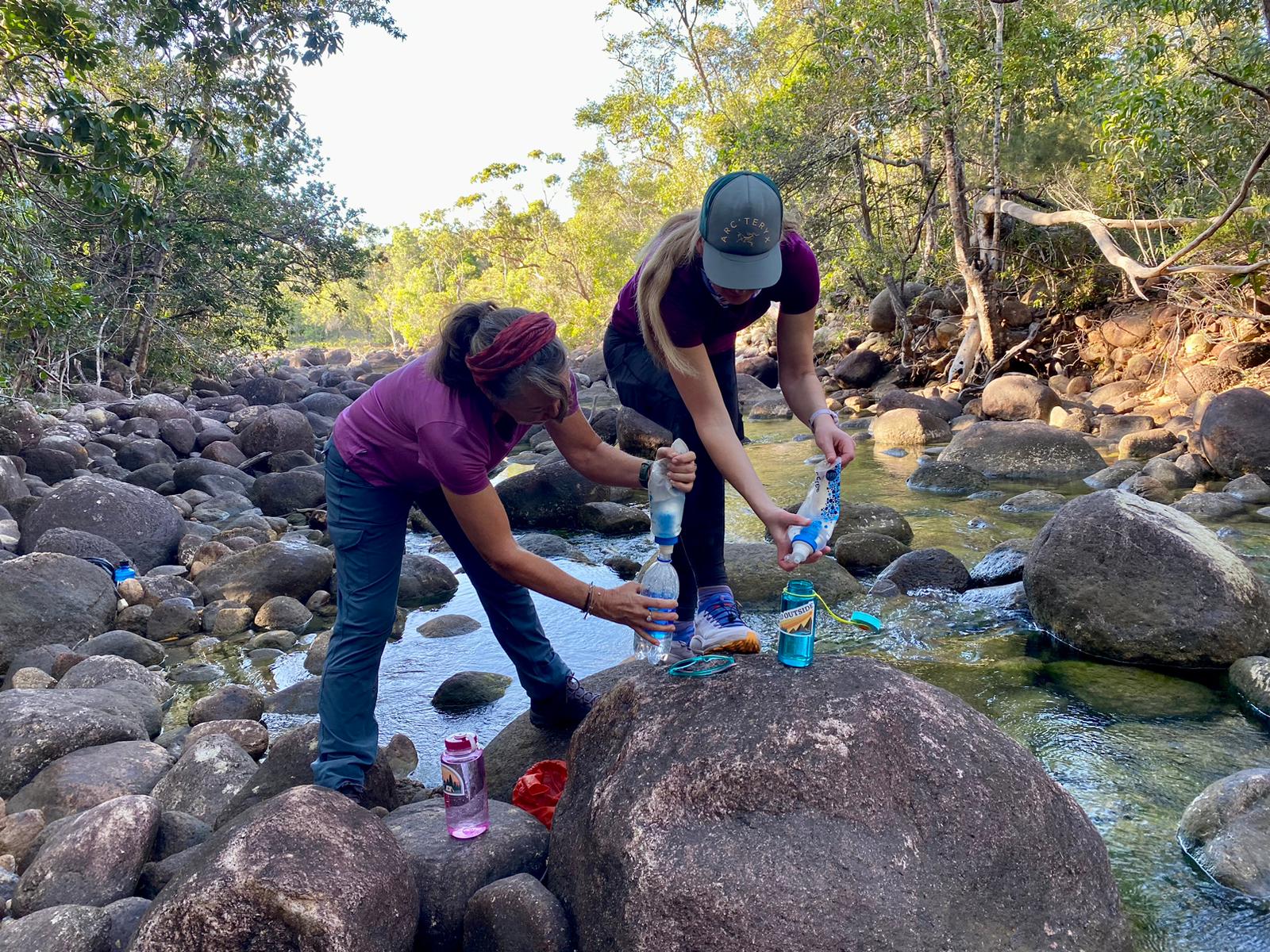 Lynne and Tash filtering water