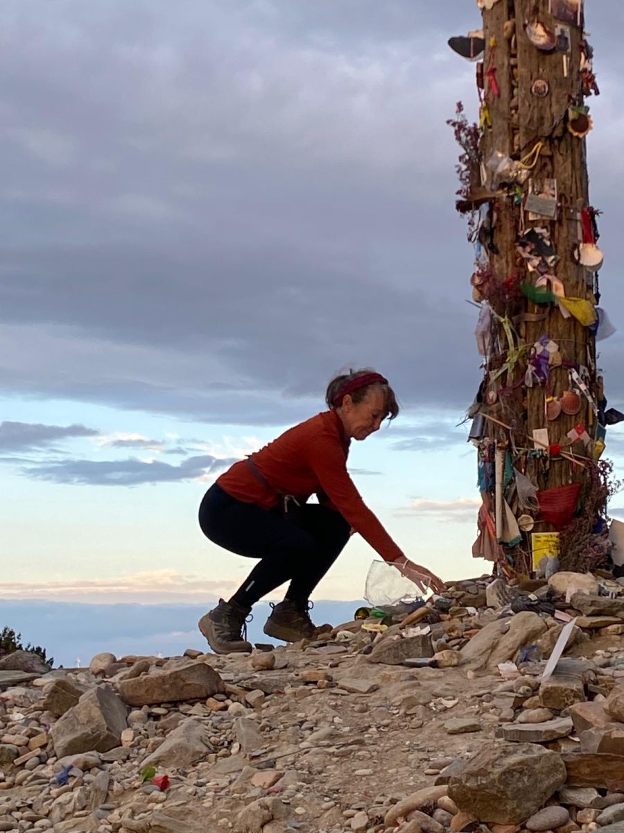 Leaving a symbolic stone at the Cruz de Ferro iron cross on the Camino Frances
