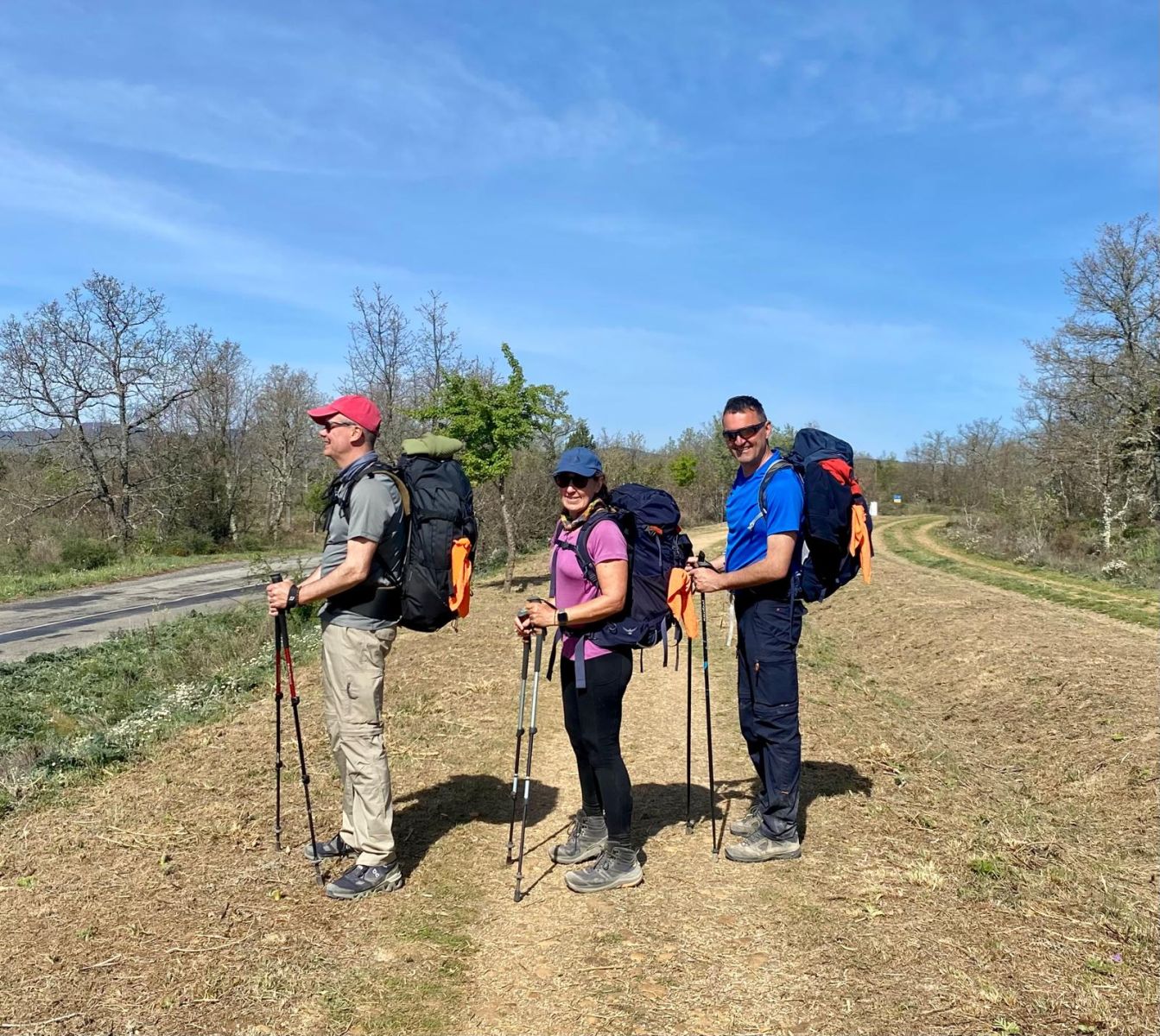 Photo of three people and their backpacks on the camino de santiago