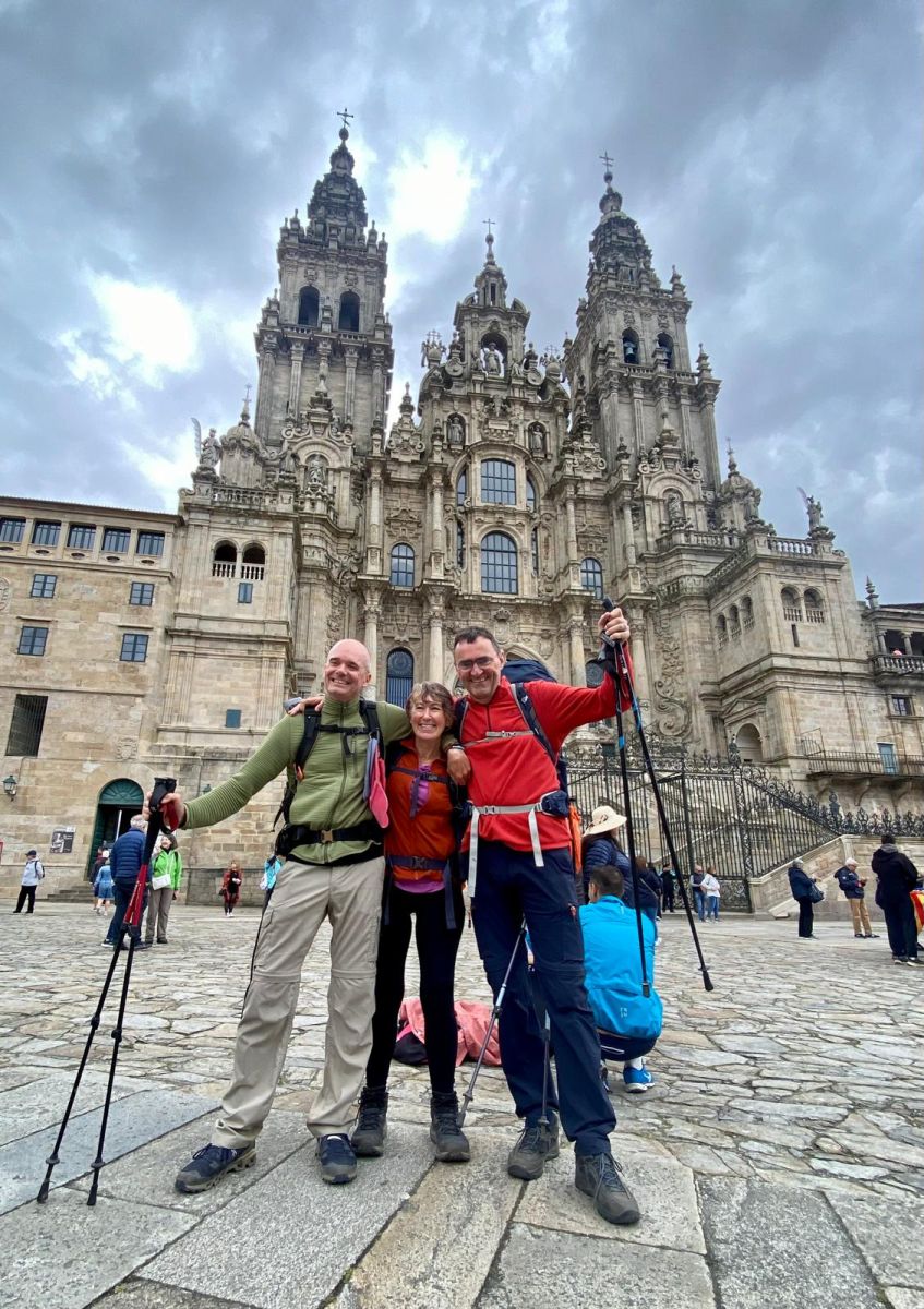 Pilgrim community and Camino family celebrating outside the Santiago de Compostela Cathedral