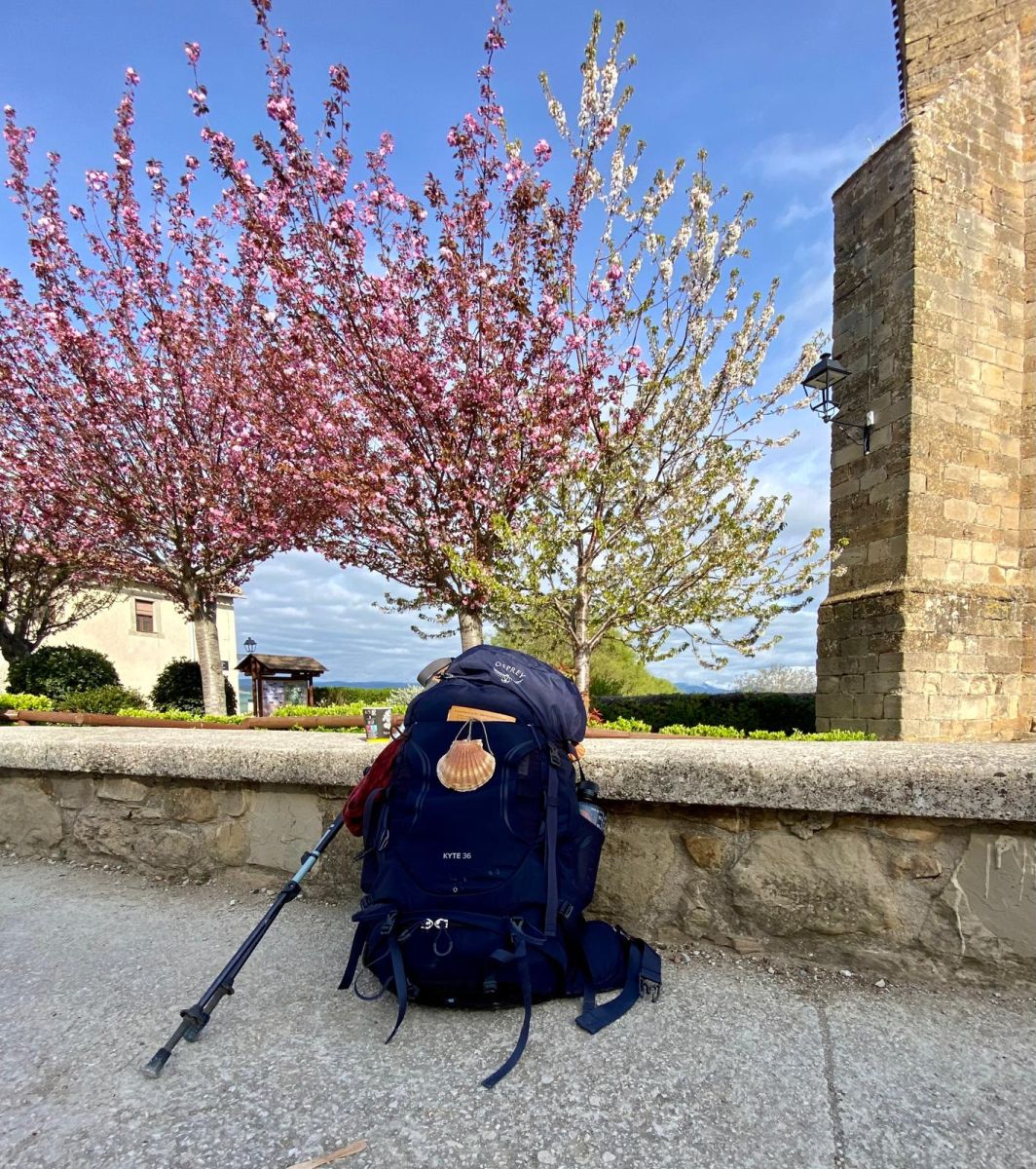 Osprey hiking backpack with trekking poles and scallop shell for the Camino de Santiago walk