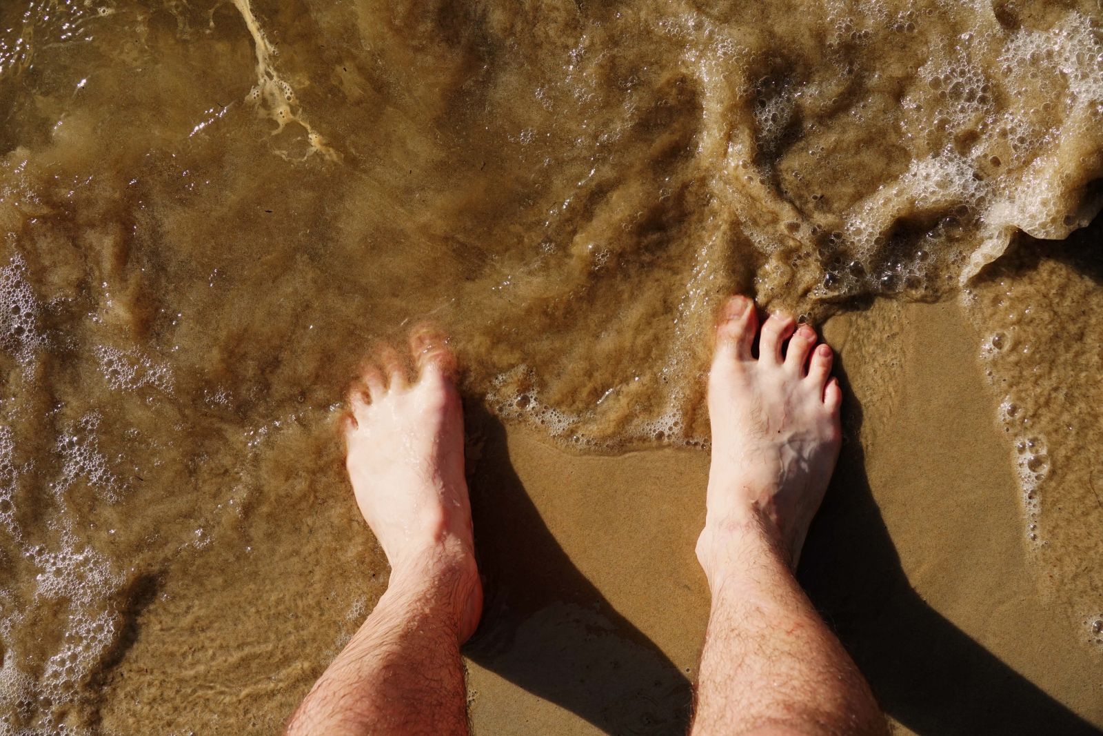 Reid's feet in the ocean