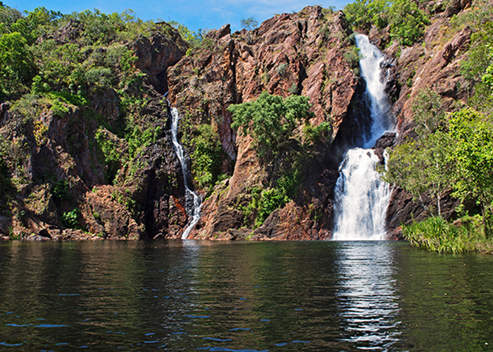 View of a waterfall spilling into the swimming hole