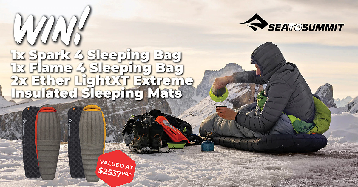 Sea to Summit Winter Prize Pack - Man sitting in a sleeping bag on top of a snow covered mountain