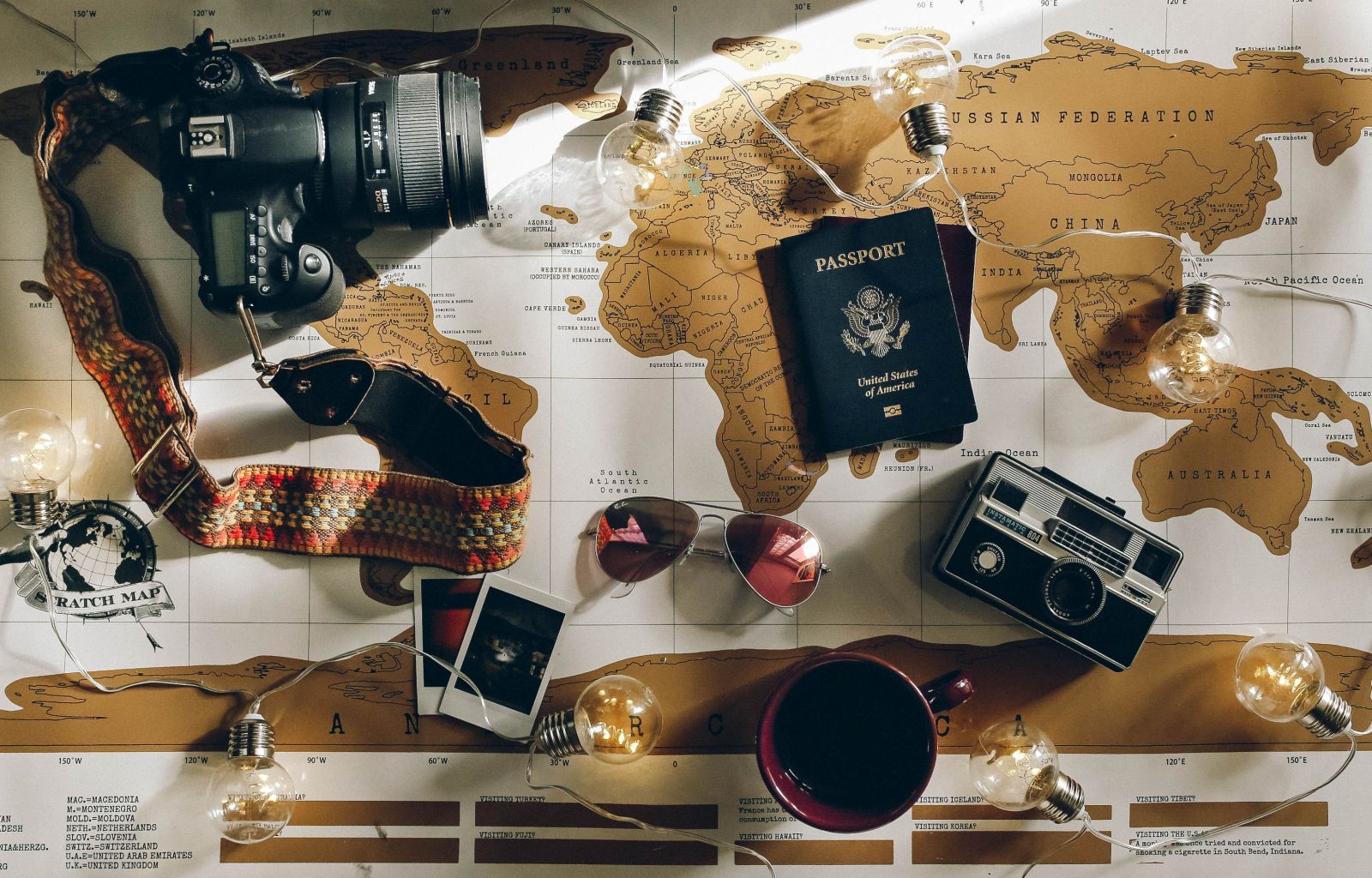 Charlotte Noelle - world map with travel essentials 