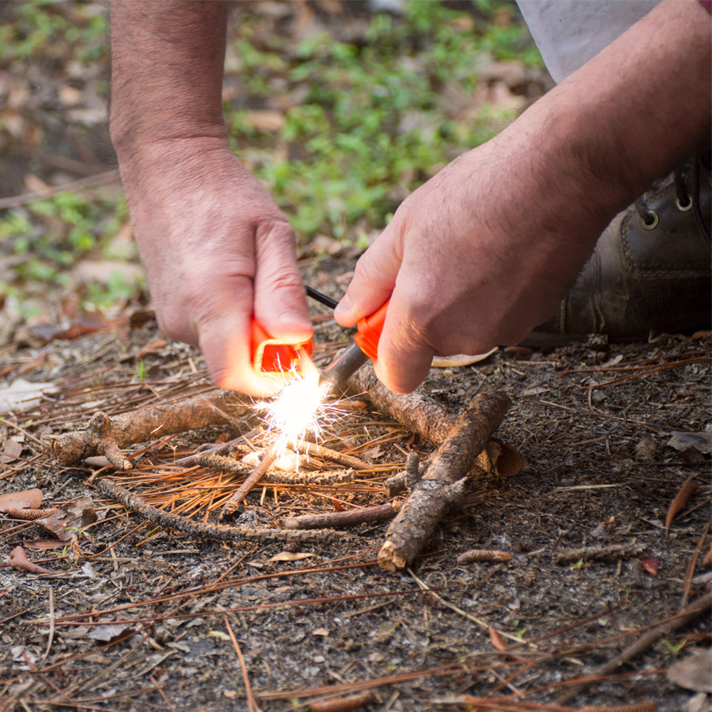Person lighting fire with fire starters