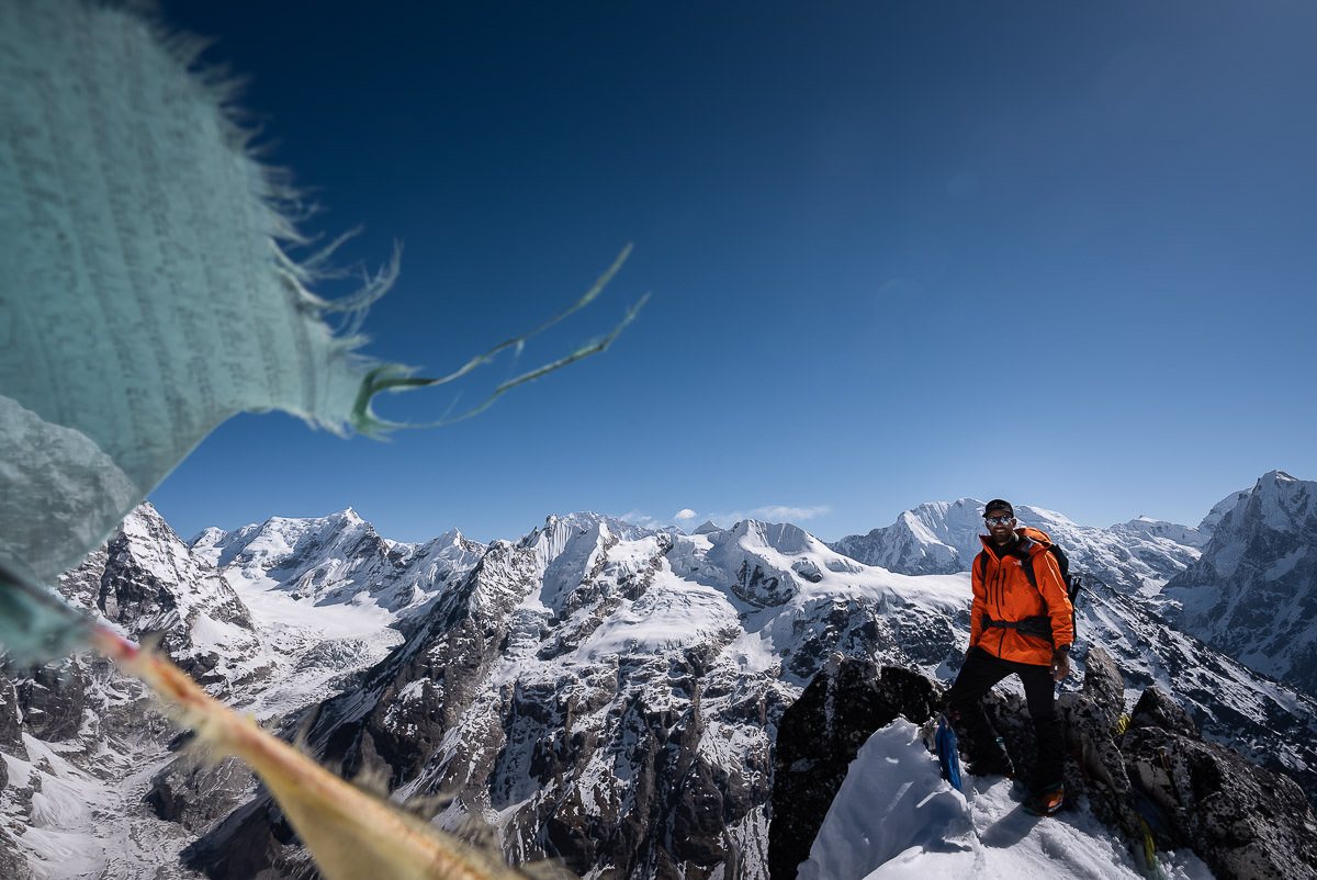 Jackson hiking in Langtang Valley with prayer flags around