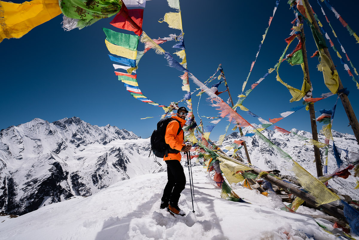 Jackson on Yala Peak surrounded by prayer flags